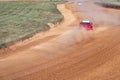 gran turismo races on the autocross track, skidding, dust and dirt from under the tires