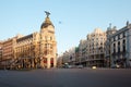 Gran Via and the iconic Metropolis Building sourrounded by trational spanish architecture at sunrise