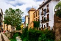 Granada, Andalusia, Spain - May 16, 2013: Medieval buildings on Carrera del Darro. Granada, Andalusia, Spain.