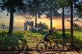 GRANADA, ANDALUSIA, SPAIN. NOVEMBER, 15TH, 2020. People having a BBQ in the forest, while a young cyclist does sport at