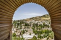 Granada cityscape viewed through arch of palace complex called Alhambra in Granada, Spain