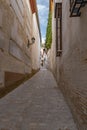 Granada empty narrow streets around Carrera Del Darro. Narrow cobbled streets of Granada in sunshine and blue sky above.