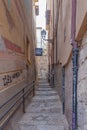 Granada empty narrow streets around Carrera Del Darro. Narrow cobbled streets of Granada in sunshine and blue sky above.