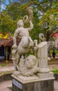 GRANADA, NICARAGUA, MAY, 14, 2018: Outdoor view of stoned statue of centaur playing a horn in a park of the city