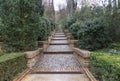 Beautiful stoned and brick stairs in middle of garden with small bushes Royalty Free Stock Photo