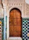 Entrance to the arabic style palace, 14th century fortress complex of Alhambra with wooden doors and colorful tiles