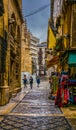 GRANADA, SPAIN, JANUARY 3, 2016: view of a street in the historical city center of spanish city granada during a rainy Royalty Free Stock Photo