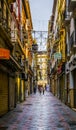 GRANADA, SPAIN, JANUARY 3, 2016: view of a street in the historical city center of spanish city granada during a rainy Royalty Free Stock Photo