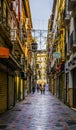 GRANADA, SPAIN, JANUARY 3, 2016: view of a street in the historical city center of spanish city granada during a rainy Royalty Free Stock Photo