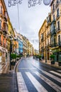 GRANADA, SPAIN, JANUARY 3, 2016: view of a street in the historical city center of spanish city granada during a rainy Royalty Free Stock Photo