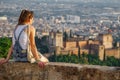 Woman at sunset over Granada and Alhambra