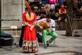 Granada, Spain - September 05, 2015: A street performer musician artist rehearsing with an acoustic guitar and a female lady with