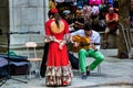 Granada, Spain - September 05, 2015: A street performer musician artist rehearsing with an acoustic guitar and a female lady with