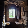 Granadilla castle interior, window with iron fence and old wooden door Royalty Free Stock Photo