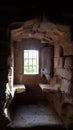 Granadilla castle interior, window with iron fence and old wooden door Royalty Free Stock Photo