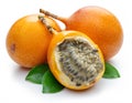 Granadilla with leaves and passion fruit half isolated on a white background Royalty Free Stock Photo