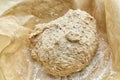 Granary bread dough, proving on baking parchment.