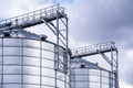 Granary elevator. Silver silos on agro-processing and manufacturing plant for processing drying cleaning and storage of