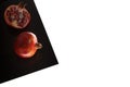 Granat Apple on Black Sheet Isolated on white Royalty Free Stock Photo