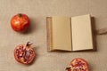 Granat Apple and Notebook lying on a sackcloth surface Royalty Free Stock Photo