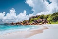 Grand Anse tropical beach in La Digue, Seychelles. Famous granite rock formations and white clouds above Royalty Free Stock Photo