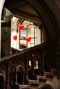 A grand, antique building in Vienna, Austria with a cluster of vibrant red heart-shaped balloons