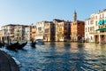 Grand canal, gondolas and pleasure boat. Campanile of Church of Santi Apostoli Royalty Free Stock Photo