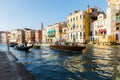 Grand canal, gondolas and pleasure boat. Campanile of Church of Santi Apostoli Royalty Free Stock Photo