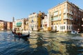 Grand canal, gondolas and pleasure boat. Campanile of Church of Santi Apostoli Royalty Free Stock Photo