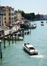 Grand Canal, poles, boats and architecture in Venice, in Europe