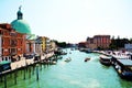 Grand Canal, poles, church, boats and architecture in Venice, in Europe