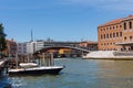 Grand Canal in Venice with boats and gandules docket motor boat near the bridge. Colorful residential house and small bridges Royalty Free Stock Photo