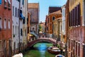 Grand Canal in Venice with boats and gandules docket motor boat near the bridge. Colorful residential house and small bridges Royalty Free Stock Photo