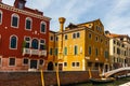 Grand Canal in Venice with boats and gandules docket motor boat near the bridge. Colorful residential house and small bridges Royalty Free Stock Photo