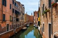 Grand Canal in Venice with boats and gandules docket motor boat near the bridge. Colorful residential house and small bridges Royalty Free Stock Photo