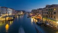 Grand Canal in Venice, Italy day to night timelapse. View on gondolas and city lights from Rialto Bridge. Royalty Free Stock Photo