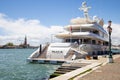 Grand canal in Venice, Italy on a sunny summer day with a luxury white yacht parked at the square.