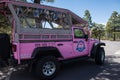 Grand Canyon, Arizona: A famous Pink Jeep Tours vehicle sits in the shade at a viewpoint along the South Rim of the