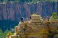 Grand Canyon,Arizona USA, JUNE, 14, 2018: Tourists standing on a steep cliff taking in the amazing view over famous Royalty Free Stock Photo