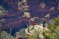 Grand Canyon,Arizona USA, JUNE, 14, 2018: Two women hiker is standing on a steep cliff taking in the amazing view over Royalty Free Stock Photo