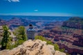 Grand Canyon,Arizona USA, JUNE, 14, 2018: View of unidentified man wearing a plaid shirt and hat, using his cellphone in Royalty Free Stock Photo