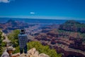 Grand Canyon,Arizona USA, JUNE, 14, 2018: View of unidentified man wearing a plaid shirt and hat, using his cellphone in Royalty Free Stock Photo