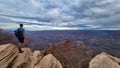 Grand Canyon - Man with panoramic aerial view from Ooh Ahh point on South Kaibab hiking trail at South Rim, Arizona, USA Royalty Free Stock Photo