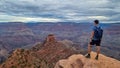 Grand Canyon - Man with panoramic aerial view from Ooh Ahh point on South Kaibab hiking trail at South Rim, Arizona, USA Royalty Free Stock Photo