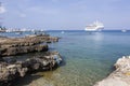 Grand Cayman Island Rocky Shore And A Cruise Ship Royalty Free Stock Photo