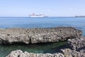 Grand Cayman Rocky Shore And A Cruise Ship Royalty Free Stock Photo
