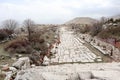 Grand colonnaded street with white marble pavement in ruins of the ancient city Sagalassos lost in Turkey mountains