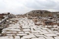 Grand colonnaded street with white marble pavement in ruins of the ancient city Sagalassos lost in Turkey mountains