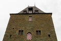 a building with flags painted on the outside of it and a clock on top