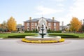 grand estate with a large fountain in the circular driveway